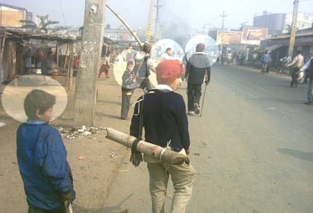 Childs making shopkeepers close their shopps with bamboo sticks